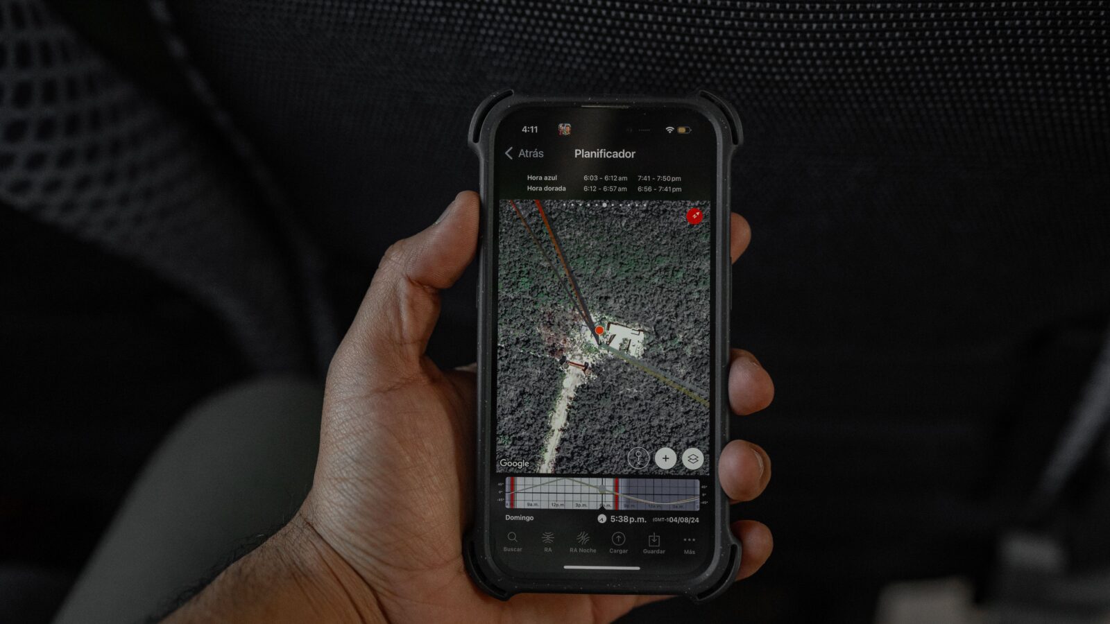 Hand houdt een smartphone vast met een kaart en locatie op het scherm